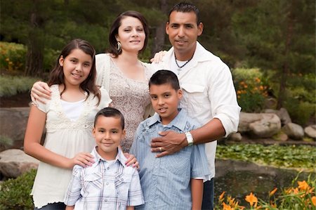 Happy Hispanic Family Portrait In the Park. Stock Photo - Budget Royalty-Free & Subscription, Code: 400-04613655