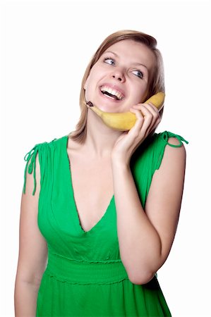 pretty women eating banana - Pretty girl in a green dress is holding a banana as a phone, isolated on white Stock Photo - Budget Royalty-Free & Subscription, Code: 400-04624056