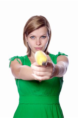pretty women eating banana - Pretty girl in a green dress is holding a banana as a gun, isolated on white Stock Photo - Budget Royalty-Free & Subscription, Code: 400-04624293