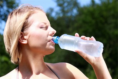 fun park mouth - Pretty woman drinking water on the summer glade Stock Photo - Budget Royalty-Free & Subscription, Code: 400-04624804