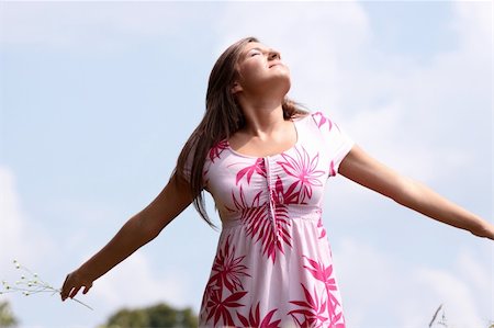 simsearch:400-04982004,k - Smile teen open hands standing on field ful of flowers Stock Photo - Budget Royalty-Free & Subscription, Code: 400-04624867