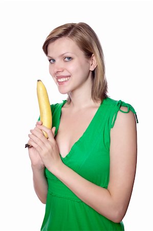 pretty women eating banana - Pretty girl in a green dress is holding a banana as a gun, isolated on white Stock Photo - Budget Royalty-Free & Subscription, Code: 400-04624959