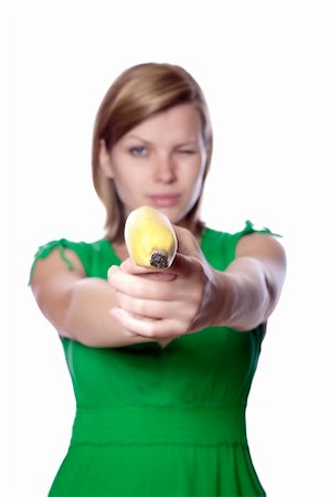 pretty women eating banana - Pretty girl in a green dress is holding a banana as a gun, isolated on white Stock Photo - Budget Royalty-Free & Subscription, Code: 400-04625701