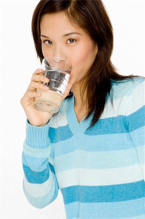 A pretty young asian woman drinking a glass of water Stock Photo - Budget Royalty-Free & Subscription, Code: 400-04625794