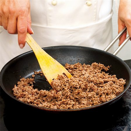 Chef frying minced meat in a pan Stock Photo - Budget Royalty-Free & Subscription, Code: 400-04626200
