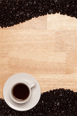 Dark Roasted Coffee Beans and Cup with Saucer on a Wood Textured Background. Stock Photo - Budget Royalty-Free & Subscription, Code: 400-04626401