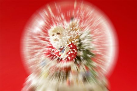 simsearch:400-07332398,k - Santa claus figurine on a glass snowing ball, red background studio shot Photographie de stock - Aubaine LD & Abonnement, Code: 400-04626423