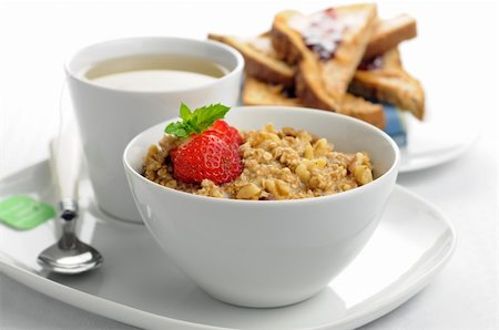 Delicious healthy oatmeal with a cup of tea and toast. Stock Photo - Budget Royalty-Free & Subscription, Code: 400-04626602