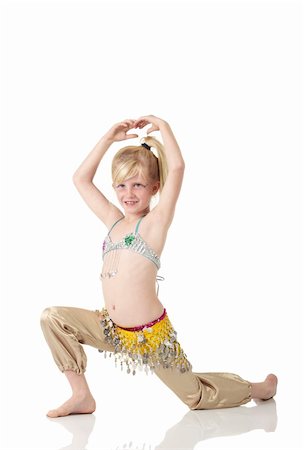 Young Caucasian belly dancing girl in beautiful decorated clothes on white background and reflective floor. Not isolated Stock Photo - Budget Royalty-Free & Subscription, Code: 400-04627209