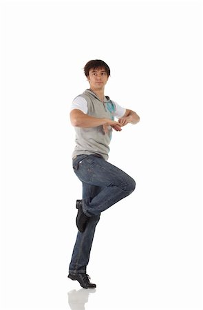 Single Caucasian male tap dancer wearing jeans showing various steps in studio with white background and reflective floor. Not isolated Stock Photo - Budget Royalty-Free & Subscription, Code: 400-04627355