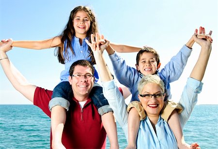 daughter riding on dads shoulders - Happy family having fun giving shoulder rides Stock Photo - Budget Royalty-Free & Subscription, Code: 400-04628394