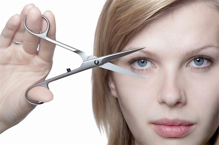 simsearch:400-04556226,k - beautiful blonde girl is looking through scissors, isolated on white Stock Photo - Budget Royalty-Free & Subscription, Code: 400-04628435