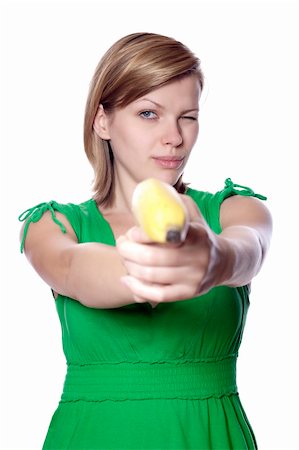 pretty women eating banana - Pretty girl in a green dress is holding a banana as a gun, isolated on white Stock Photo - Budget Royalty-Free & Subscription, Code: 400-04628430