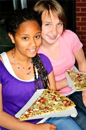 Two teenage girls sitting and eating pizza Stock Photo - Budget Royalty-Free & Subscription, Code: 400-04628978