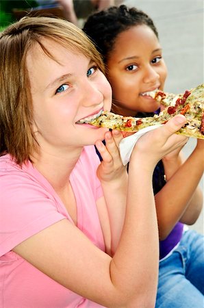 Two teenage girls sitting and eating pizza Stock Photo - Budget Royalty-Free & Subscription, Code: 400-04628980