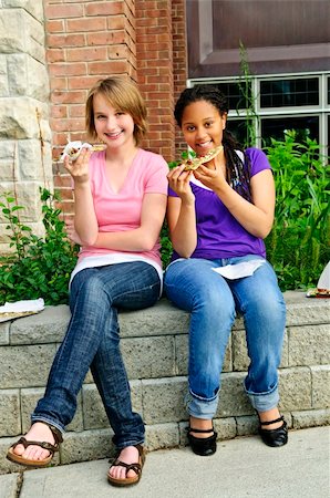 Two teenage girls sitting and eating pizza Stock Photo - Budget Royalty-Free & Subscription, Code: 400-04628981