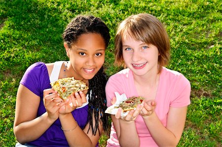 Two teenage girls sitting and eating pizza Stock Photo - Budget Royalty-Free & Subscription, Code: 400-04628982