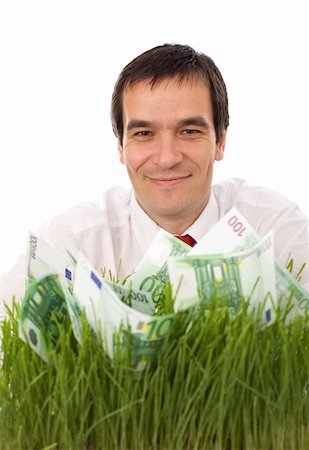 sustainable money - Businessman with green banknotes in the grass - isolated environment friendly business concept Stock Photo - Budget Royalty-Free & Subscription, Code: 400-04629629