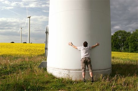 simsearch:400-04465410,k - Man embraces a Windmill in front of a rape field Stock Photo - Budget Royalty-Free & Subscription, Code: 400-04629819