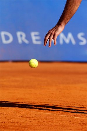 Man with tennis ball on a clay court Stock Photo - Budget Royalty-Free & Subscription, Code: 400-04620164