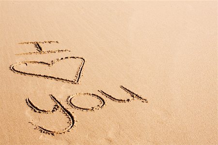 The words "I love you" written on the beach sand. The word love is represented by a heart symbol. Stock Photo - Budget Royalty-Free & Subscription, Code: 400-04621323