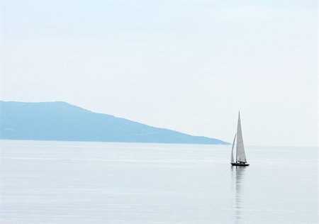 Vast open water surface with a small sailing boat Stock Photo - Budget Royalty-Free & Subscription, Code: 400-04621394