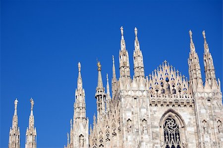 The famous Duomo, cathedral church of Milan, Italy. Details of spires with the "Madonnina" statue of the Virgin Mary Stock Photo - Budget Royalty-Free & Subscription, Code: 400-04621578