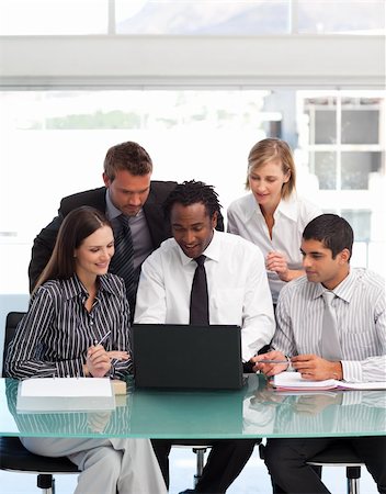 International business team using a laptop together Stock Photo - Budget Royalty-Free & Subscription, Code: 400-04621582