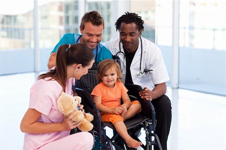 Little patient with medical team in a wheelchair Stock Photo - Budget Royalty-Free & Subscription, Code: 400-04621649