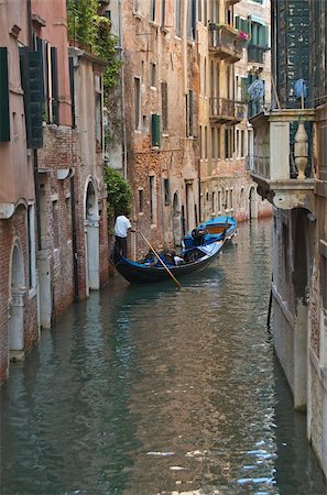selloutphotos (artist) - view down a water canal in Venice, Italy with a Gondola Stockbilder - Microstock & Abonnement, Bildnummer: 400-04621845
