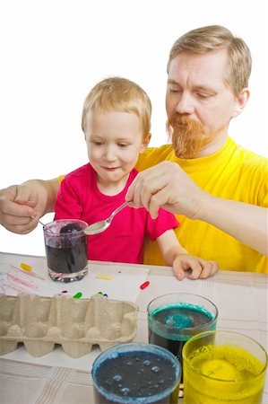 The man and the boy take out an Easter egg from a glass with a paint Foto de stock - Super Valor sin royalties y Suscripción, Código: 400-04621984