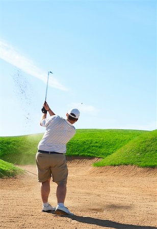 simsearch:400-03912170,k - Young male golfer hitting the ball from the sand bunker on a beautiful summer day Foto de stock - Super Valor sin royalties y Suscripción, Código: 400-04622369