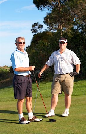 simsearch:400-04622368,k - Young male golfer with his senior father ready to tee off on a beautiful summer day Foto de stock - Super Valor sin royalties y Suscripción, Código: 400-04622375