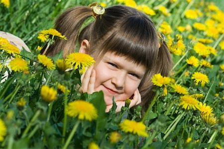 simsearch:400-04399399,k - Little cool smiling girl is lying on the flowering dandelion meadow Foto de stock - Super Valor sin royalties y Suscripción, Código: 400-04622799