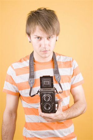 foto_freelancer (artist) - young guy holding a camera Stock Photo - Budget Royalty-Free & Subscription, Code: 400-04623099