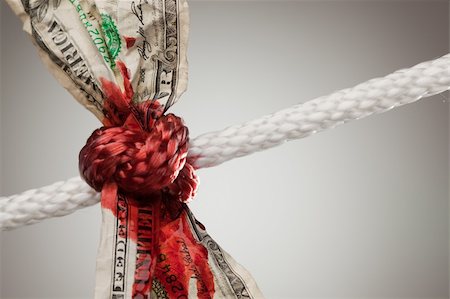 simsearch:400-05062045,k - Wrinkled American Dollar Tied Up and Bleeding in Rope. Fotografie stock - Microstock e Abbonamento, Codice: 400-04623260