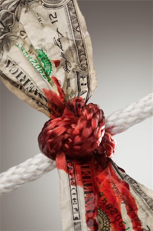 simsearch:400-05062045,k - Wrinkled American Dollar Tied Up and Bleeding in Rope. Fotografie stock - Microstock e Abbonamento, Codice: 400-04623261