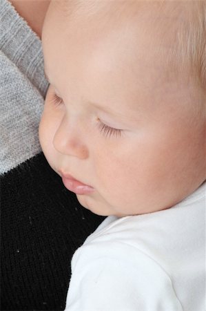 A mother and her tired cute baby boy isolated on white background Stock Photo - Budget Royalty-Free & Subscription, Code: 400-04623490