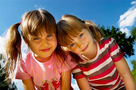 Two little smiling girls in the park Fotografie stock - Microstock e Abbonamento, Codice: 400-04623728