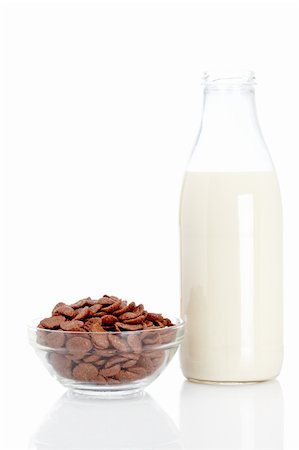 simsearch:400-03917186,k - A bowl of chocolate cornflakes and milk bottle on white background.. Shallow depth of field Stock Photo - Budget Royalty-Free & Subscription, Code: 400-04623955