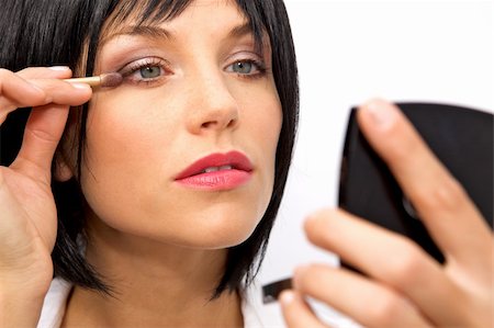 A beatiful woman applying eyeshadow over her eyes Stock Photo - Budget Royalty-Free & Subscription, Code: 400-04634165