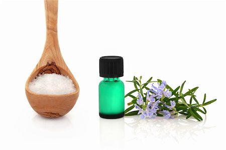 simsearch:400-04154039,k - Rosemary herb leaf sprig in flower with a green aromatherapy essential oil bottle and sea salt in an olive wood ladle, over white background. Stock Photo - Budget Royalty-Free & Subscription, Code: 400-04634180