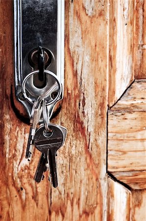 Set of keys in lock of old wooden door Stock Photo - Budget Royalty-Free & Subscription, Code: 400-04634312