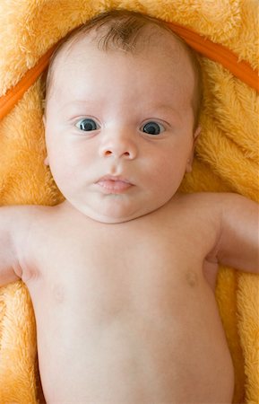 simsearch:400-03947588,k - Closeup Portrait of baby boy lying on the orange blanket Foto de stock - Super Valor sin royalties y Suscripción, Código: 400-04634779