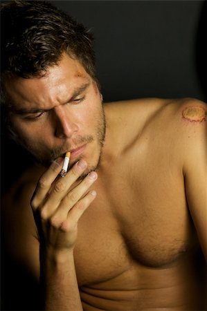 scars - A portrait of a young sexy man smoking a cigarette Stock Photo - Budget Royalty-Free & Subscription, Code: 400-04635629