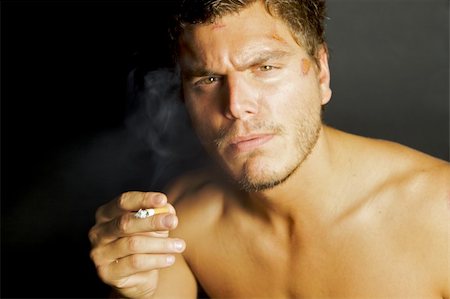 drogato - A portrait of a young sexy man smoking a cigarette Fotografie stock - Microstock e Abbonamento, Codice: 400-04635635