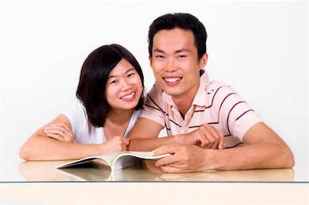 people laughing magazine - Asian couples sharing a book. Stock Photo - Budget Royalty-Free & Subscription, Code: 400-04635717