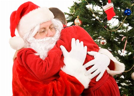 people together on a christmas morning - Santa getting a big hug from a child on Christmas morning. Stock Photo - Budget Royalty-Free & Subscription, Code: 400-04636742