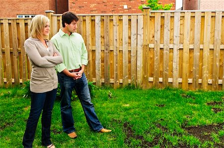 simsearch:400-08074641,k - Young couple worried about growing lawn in backyard of new home Stock Photo - Budget Royalty-Free & Subscription, Code: 400-04636781