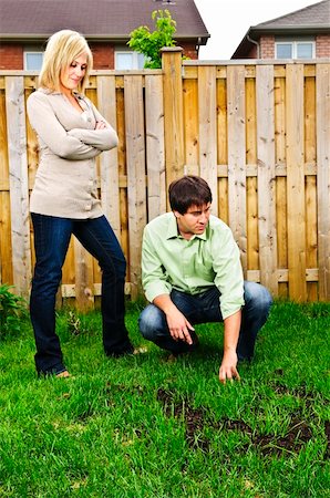 simsearch:400-08074641,k - Young couple worried about growing lawn in backyard of new home Stock Photo - Budget Royalty-Free & Subscription, Code: 400-04636783